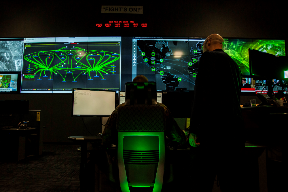 Cybersecurity personnel observing information on computer monitors