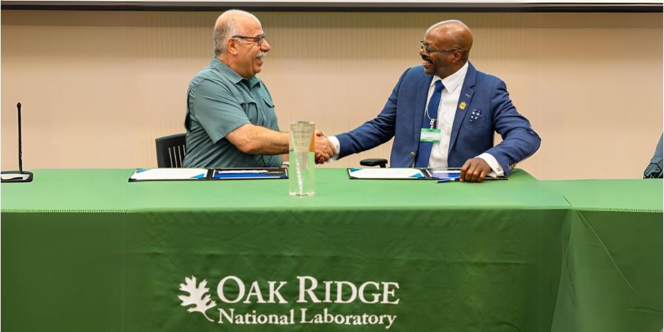 ORNL's Moe Khaleel, left, associate laboratory director for national security sciences, and Maurice Singleton III, chief executive officer of U2opia Technology, celebrate the partnership between Oak Ridge National Laboratory and U2opia Technology. Credit: Carlos Jones/ORNL, U.S. Dept. of Energy