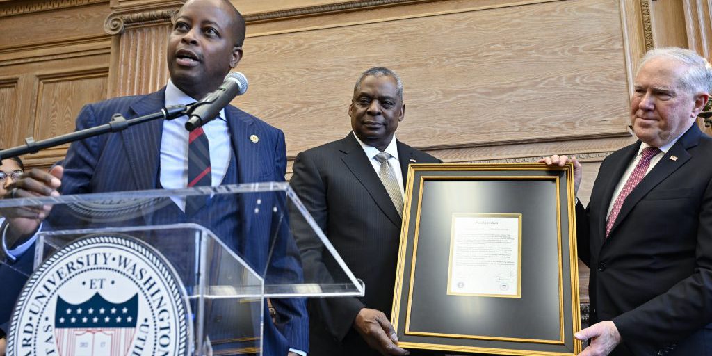 Howard University President Dr. Wayne Frederick (left), Secretary of Defense Lloyd Austin (middle), and Secretary of the Air Force Frank Kendall (right) hold a proclamation announcing the partnership of Howard University as an Air Force university-affiliated research center during a ceremony at the university in Washington, D.C., January 23, 2023  (U.S. Air Force photo by Eric Dietrich).