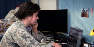 A senior cadet attends a class remotely via video chat from her dorm room on March 19, 2020 in Vandenberg Hall at the U.S. Air Force Academy. DARPA program manager Wil Corvey envisions AI tutoring as a way to enhance remote and self-directed learning (U.S. Air Force photo/Trevor Cokley).