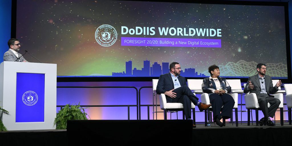 Former Defense Intelligence Agency (DIA) Chief Information Officers (CIO) speak on the Former DIA CIO Panel at the 2021 Department of Defense Intelligence Information System (DoDIIS) worldwide conference on December 7, 2021. From left to right: Doug Cossa, current DIA CIO; Jack Gumtow, former DIA CIO; Janice Glover-Jones, former DIA CIO; and Grant Schneider, former DIA CIO. DIA’s annual DoDIIS worldwide conference brings together experts from Government, military, industry and academia in order to tackle information technology challenges and complexities impacting the Intelligence Community.