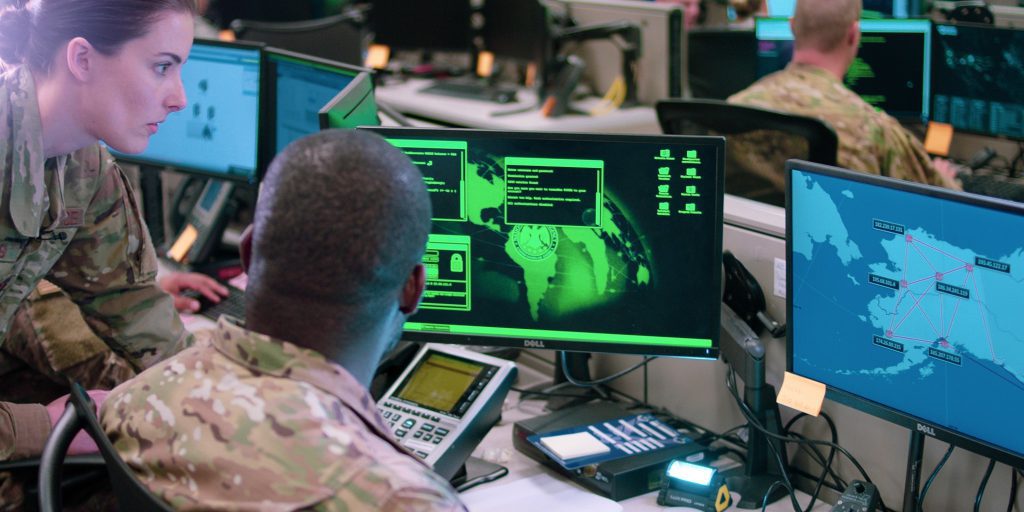 Capt. Sarah Miller and Tech. Sgt. Carrol Brewster, 834th Cyber Operations Squadron, discuss options in response to a staged cyber attack during filming of a scene for an Air Force Reserve Command mission video at Joint Base San Antonio-Lackland, Texas, on June 1, 2019. The video, which is currently in production, will also be filmed at Joint Base Elmendorf-Richardson, Alaska; and Colorado Springs, Colorado. The completed video will portray Reserve Airmen conducting multi-domain operations across air, space and cyberspace, and is scheduled to premiere later this year. (U.S. Air Force Photo by Maj. Christopher Vasquez)